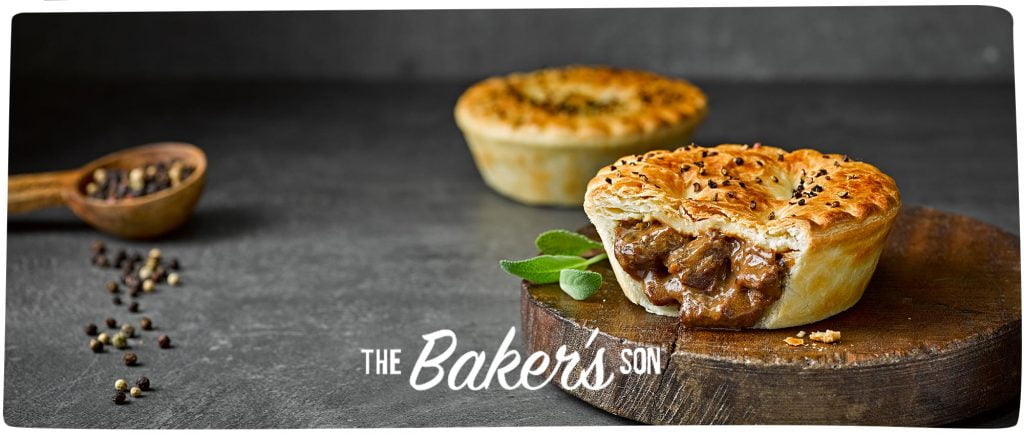 A closeup of a meat-filled pie pastry with the words Baker's son